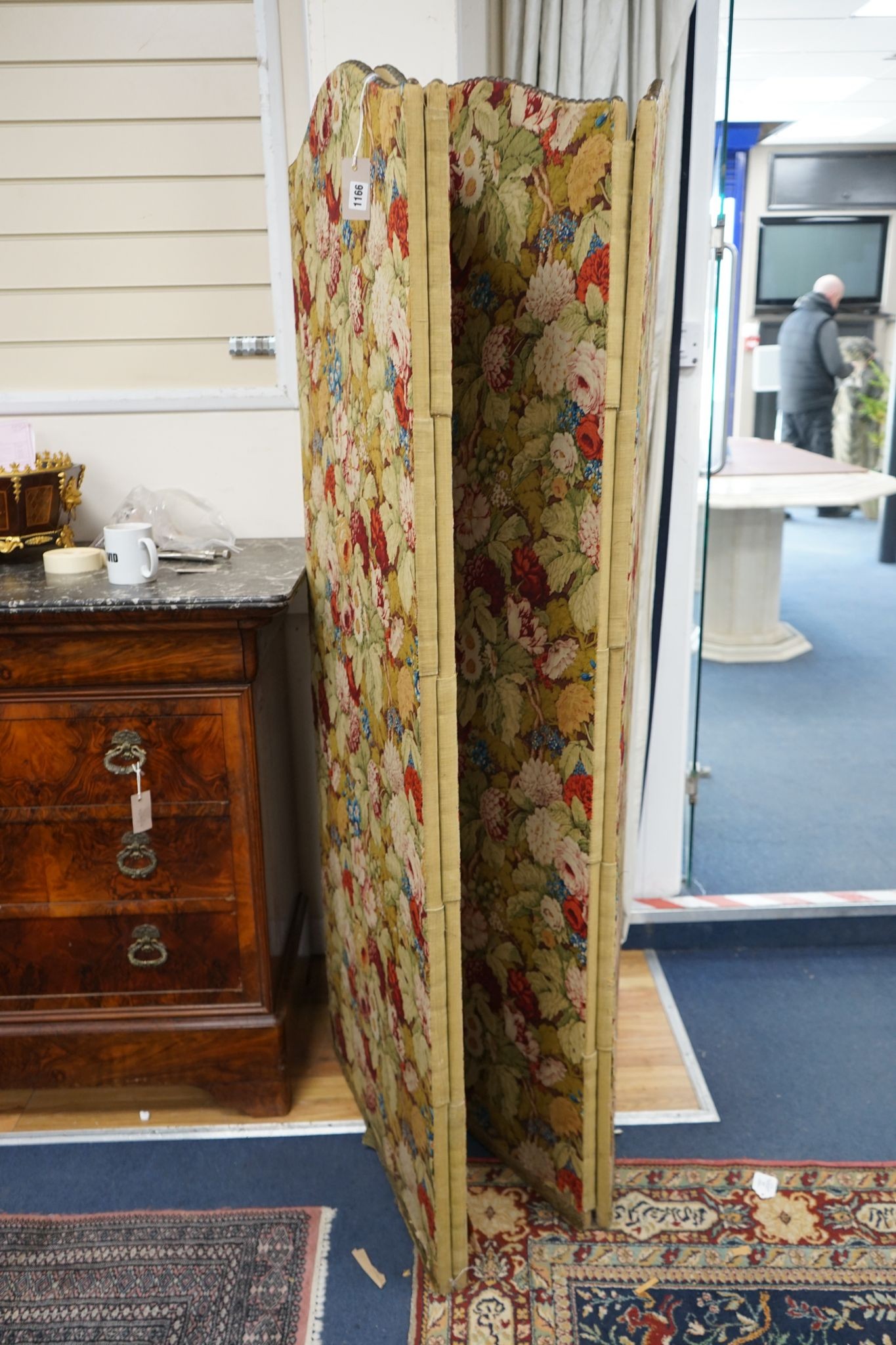 An early 20th century floral fabric four fold dressing screen, each panel width 67cm, height 176cm